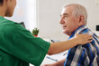 © DragonImages - Senior man looking at medical nurse touching his shoulder when telling diagnosis