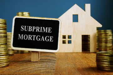 Wall Mural - Subprime mortgage plate and model of home.