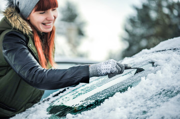 Wall Mural - Clean car window from snow. Winter windshield car cleaning. Removing snow from window.