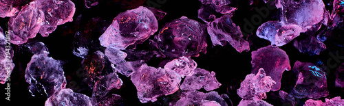 Cuadros en Lienzo panoramic shot of transparent ice cubes with purple illumination isolated on bla