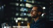 © Kitreel - Portrait of an young business man is wearing handsfree earphones in the evening in a city center.