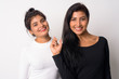 © Ranta Images - Two happy young beautiful Persian women smiling together