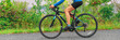 © Maridav - Road bike cyclist woman riding bicycle panoramic banner of legs and wheels. Sport active lifestyle panorama.