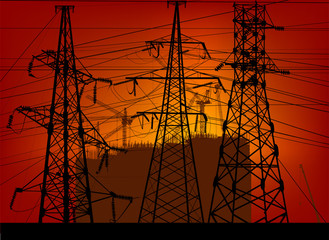 Wall Mural - electric towers in front of dark buildings on sunset background