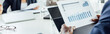 © LIGHTFIELD STUDIOS - panoramic shot of african american businessman holding document with graphs in office