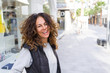 © Krakenimages.com - Beautiful sporty woman with curly hair smiling cheerful walking on the streets at the town