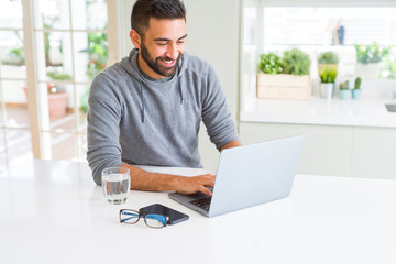 Wall Mural - Man smiling working using computer laptop