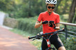 © lzf - Riding on bike path,using smartphone while riding bike on sunny day