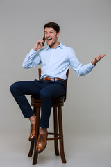 Sticker - Full length portrait of happy businessman talking on cellphone