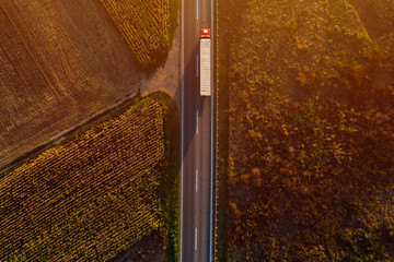 Truck on the road in sunset, top view