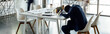 © LIGHTFIELD STUDIOS - panoramic shot of african american businessman sleeping on table in office