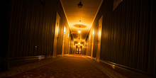Long Dark Vintage Motel Corridor With Closed Doors
