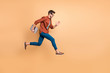 © deagreez - Full length body size view of his he nice attractive cheerful cheery successful brunet guy jumping in air carrying laptop running fast late hurry-up isolated over beige color pastel background