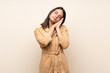 © luismolinero - Young girl over isolated background making sleep gesture in dorable expression