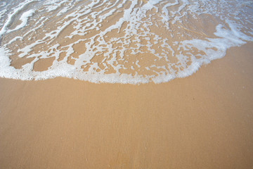 oft wave of blue ocean on sandy beach. Copy space for text