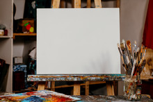 Art Equipment: Easel, Brushes, Tubes With Paint, Palette And Paintings