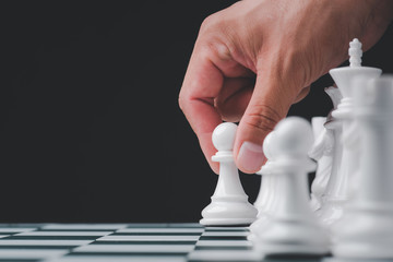 Businessman hand play with chess game. concept of business strategy and tactic.strategy, management or leadership concept