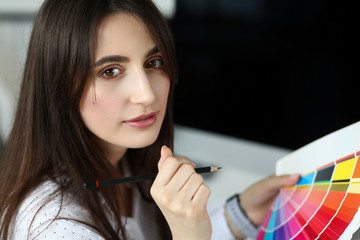 Wall Mural - Pretty caucasian adult woman picking color using fantail palette headshot