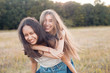 © Dima Aslanian - Two happy young women having fun outdoors. Best friends
