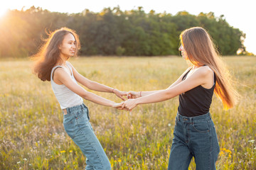 Two beautiful young women having fun outdoors under sunlight, Best friends