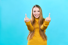 Young beautiful woman standing over isolated blue background Showing middle finger doing fuck you bad expression,