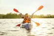 © master1305 - Happy young caucasian couple kayaking on river with sunset in the backgrounds. Having fun in leisure activity. Happy male and female model laughting on the kayak. Sport, relations concept. Colorful.