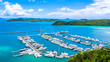 Beautiful port yachts and boats in marina bay, Aerial view of yachts and boat in the marina clear water with blue sky background.