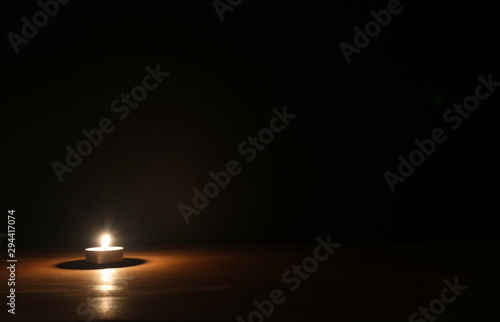 Cuadros en Lienzo Burning candle over black background