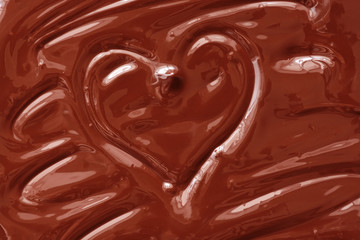 Melted chocolate heart background. The texture of liquid dark chocolate.