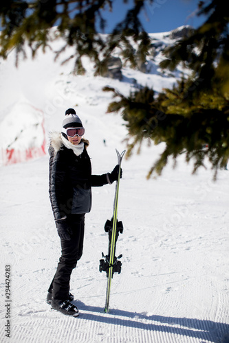 Young Woman With Ski Equipment Spending Winter Vacation At