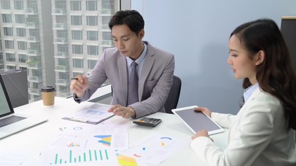 Wall Mural - Young Asian businessman discussing sales documents in the meeting at the office in the city