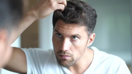 Wall Mural - Portrait of a man in front of mirror 