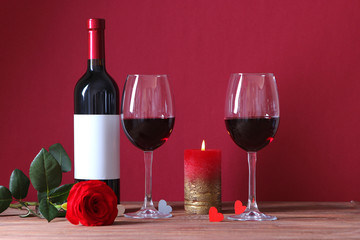 red wine and roses on the table. Valentine's day background. A gala dinner for two.