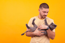 Handsome Young Man Loving And Holding His Cat