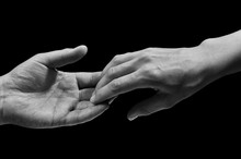 Black And White Photo Of Two Hands At The Moment Of Breakup. The Concept Of  Breakup. On Black Isolated Background. Image.