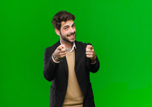 Young Businessman Feeling Happy And Confident, Pointing To Camera With Both Hands And Laughing, Choosing You Against Green Background