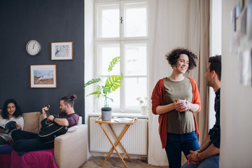 A group of young friends indoors at home, house sharing concept.