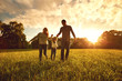 © Studio Romantic - Happy family walks on the park at sunset.