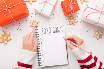Sticker - Woman in striped sweater writing 2020 goals and Christmas wishe
