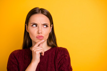 Wall Mural - Close up photo of attractive charming pretty cute girl touching her chin while pondering over something being isolated with yellow background