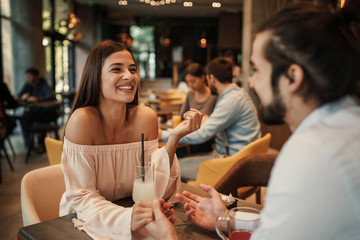 Poster - Young happy couple at a date in a cafe