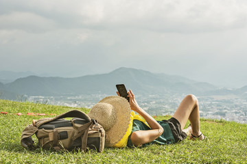 Wall Mural - woman lie on grassland and take a picture