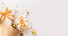 Present Boxes With Gold Ribbon Inside Shopping Bag On White