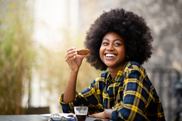 Sticker - happy young black woman eating cookie