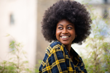 Wall Mural - horizontal portrait of young black woman with afro hair smiling