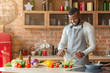 © Prostock-studio - Handsome man preparing fresh healthy salad at kitchen