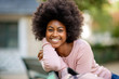 Close up smiling young african american lady with afro hair outside