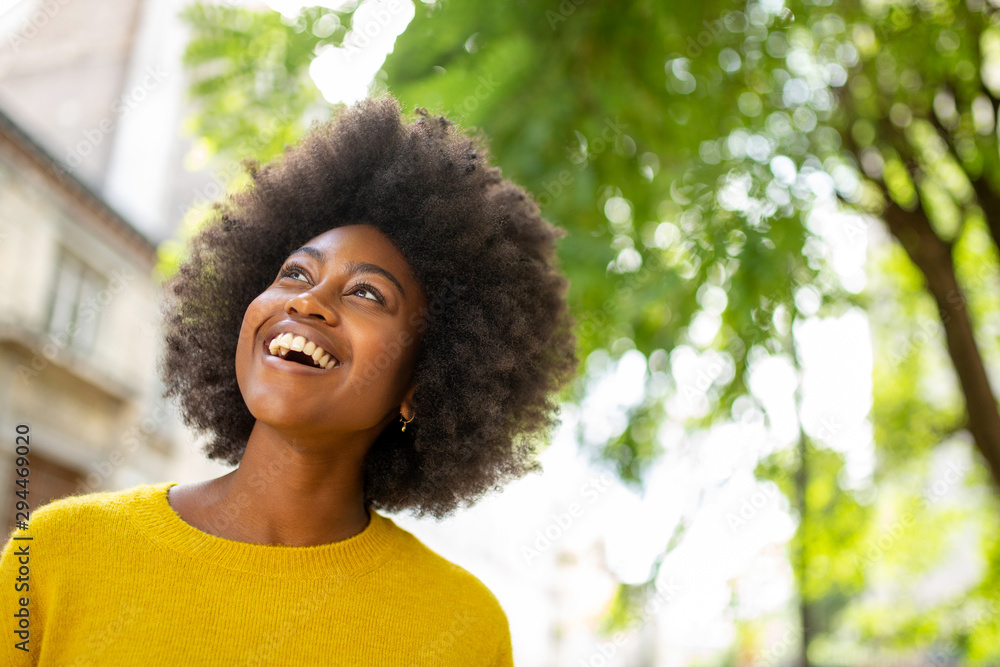 beautiful young afro american woman laughing outside - obrazy, fototapety, plakaty 