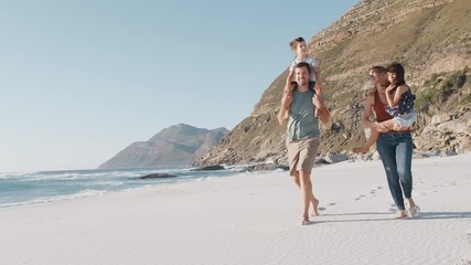 Wall Mural - Family Walking Along Beautiful Sandy Beach On Summer Vacation 