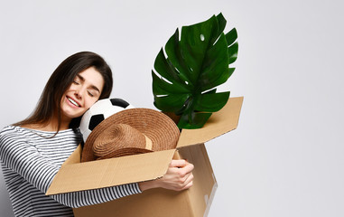 Young woman holding box with things.